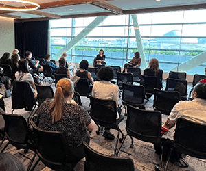 audience interacting with two seminar speakers